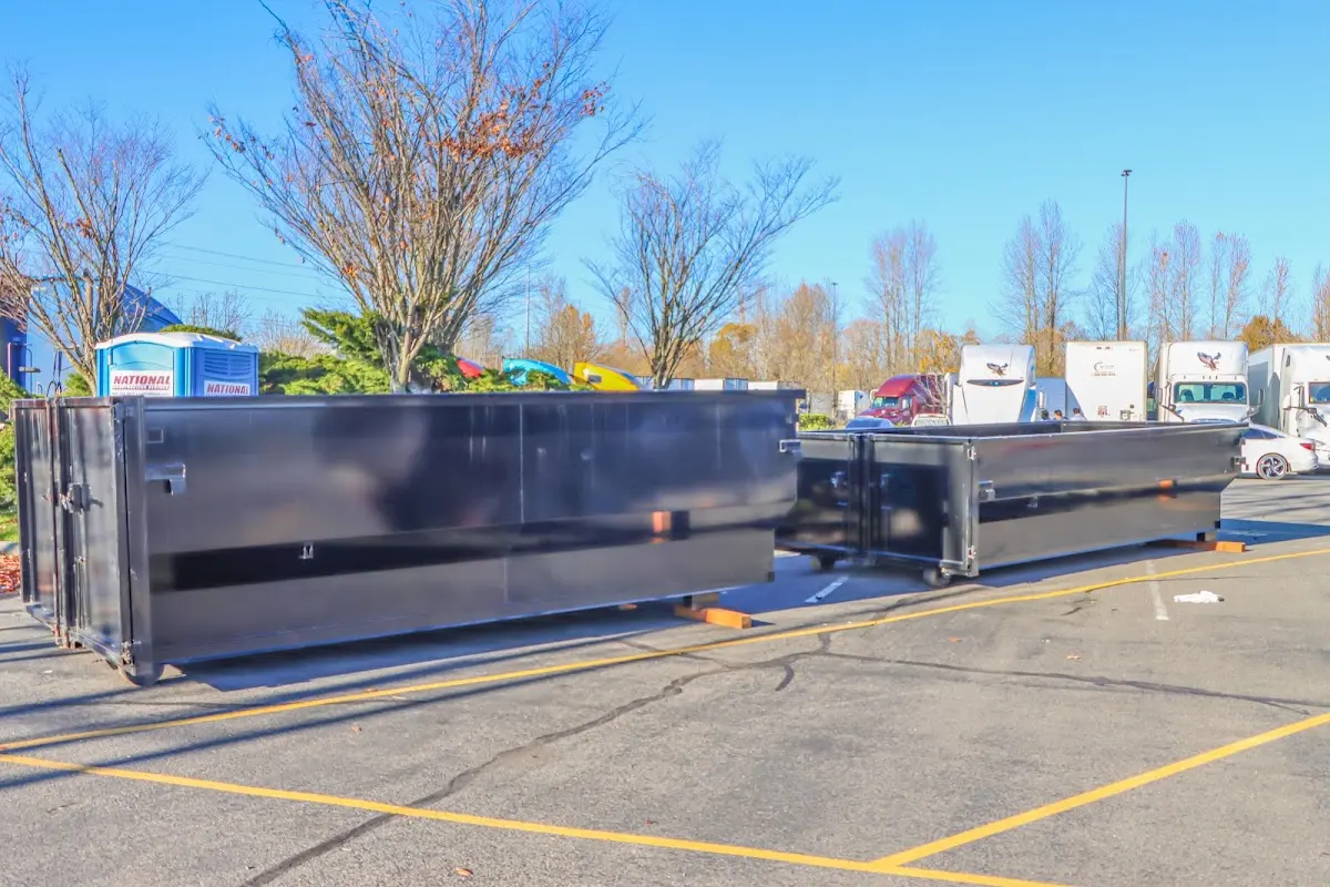 Professional dumpster rental service with roll-off container on residential driveway in Ripley